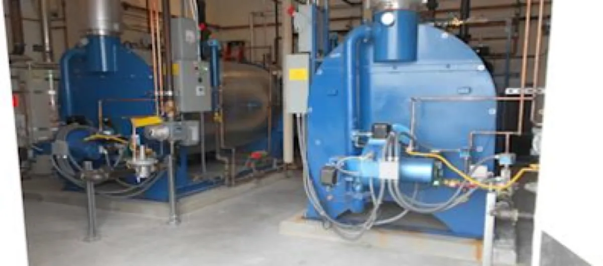 Twin Scotch fuel-fired boilers installed in mechanical room